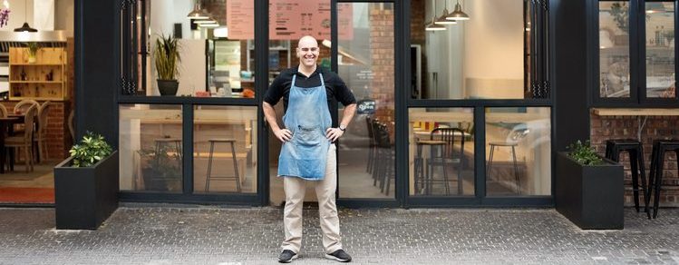 Entrepreneur standing in front of his fast food restaurant