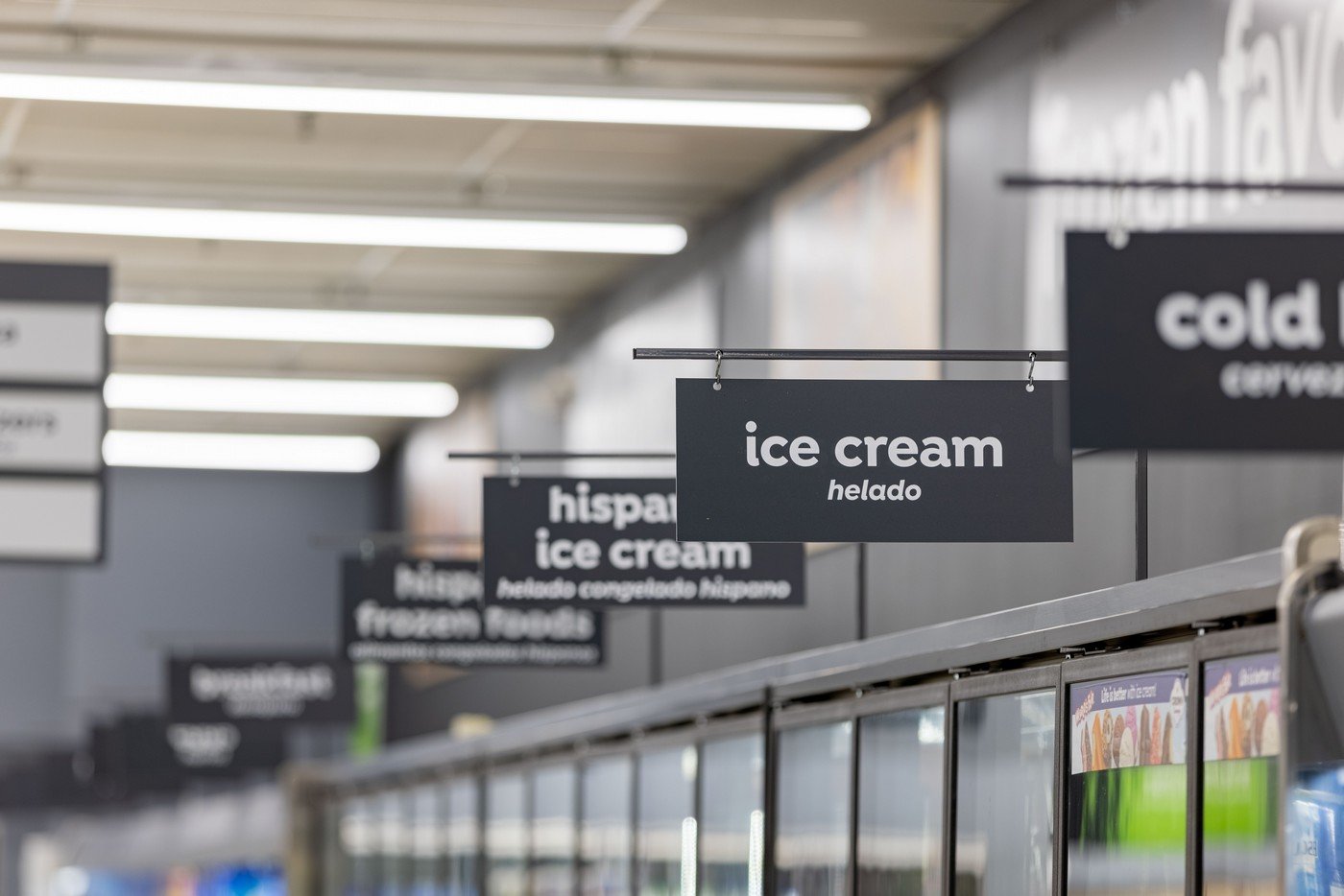 Supermarket signage design for ice cream displays. White text on black background provides a legible contrast.