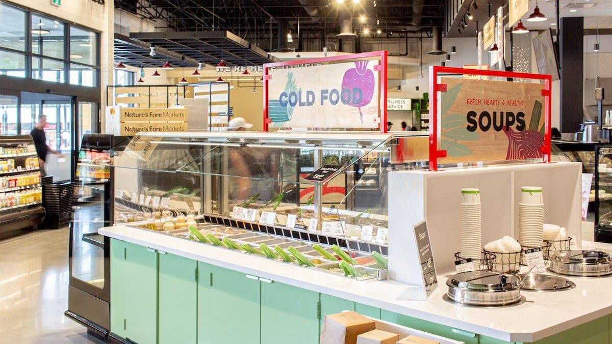Gondola aisle sign holders providing information to the customers at a food bar in a grocery store